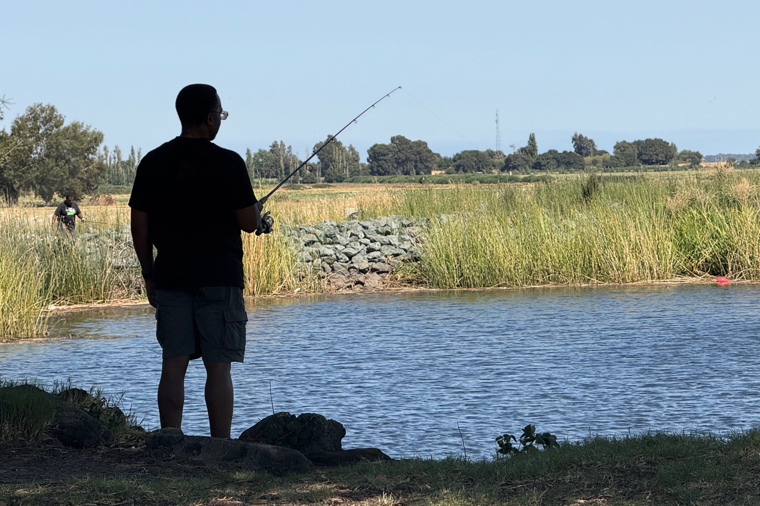 person fishing on a river