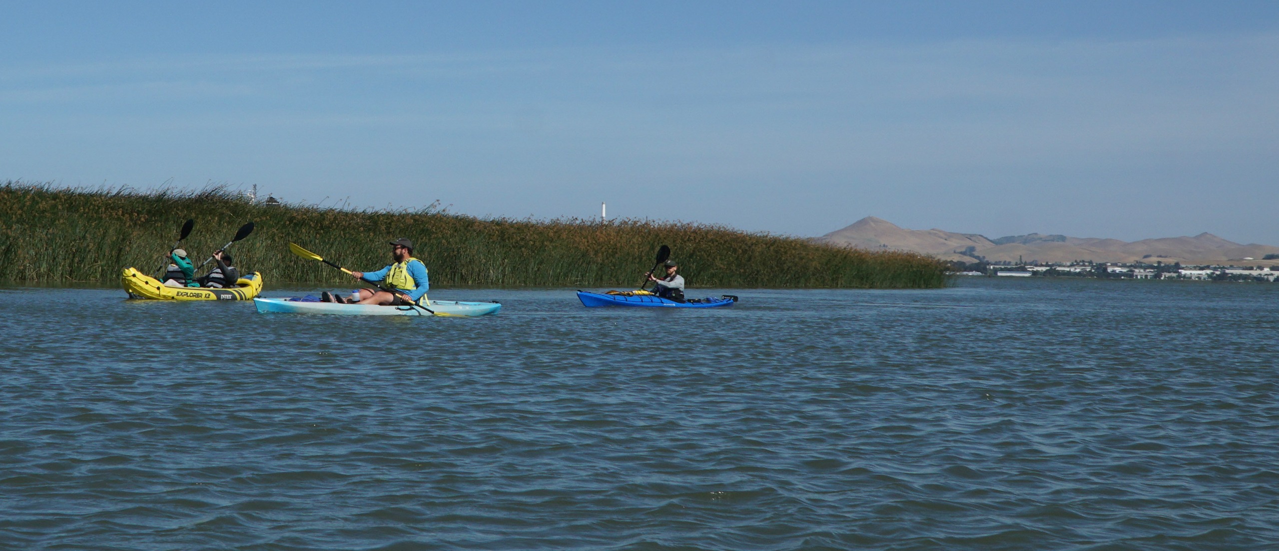 People kayak in a river